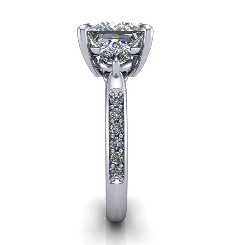 Blake princess three stone engagement ring in 14K White Gold, side profile showing the round side stone and the pav&eacute; diamonds running down the shank