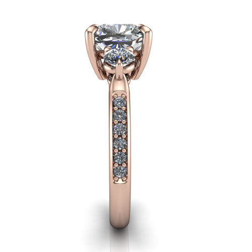 Blake cushion three stone engagement ring in 18K Rose Gold, side profile showing the round side stone and the pav&eacute; diamonds running down the shank