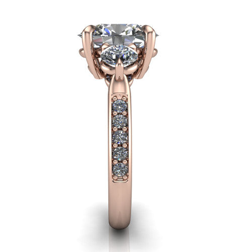 Blake oval three stone engagement ring in 18K Rose Gold, side profile showing the round side stone and the pav&eacute; diamonds running down the shank