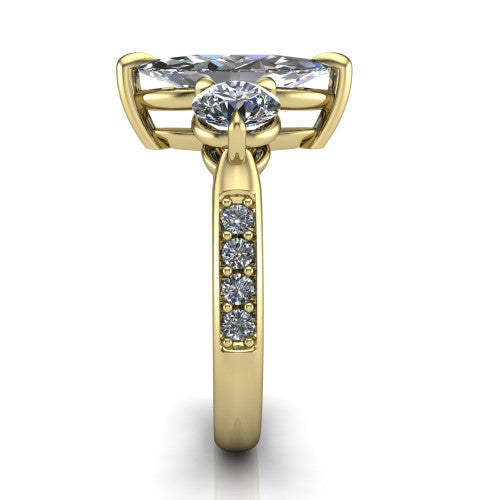 Blake marquise three stone engagement ring in 18K Yellow Gold, side profile showing the round side stone and the pav&eacute; diamonds running down the shank