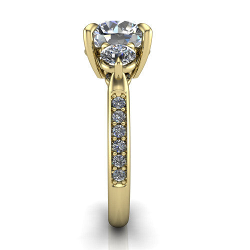 Blake round three stone engagement ring in 14K Yellow Gold, side profile showing the round side stone and the pav&eacute; diamonds running down the shank