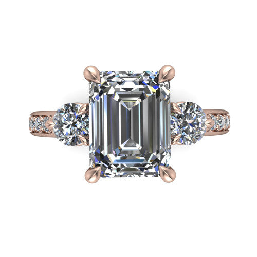 Blake emerald three stone engagement ring in 14K Rose Gold, through-finger front profile showing the three-stone head raised above the pav&eacute; band