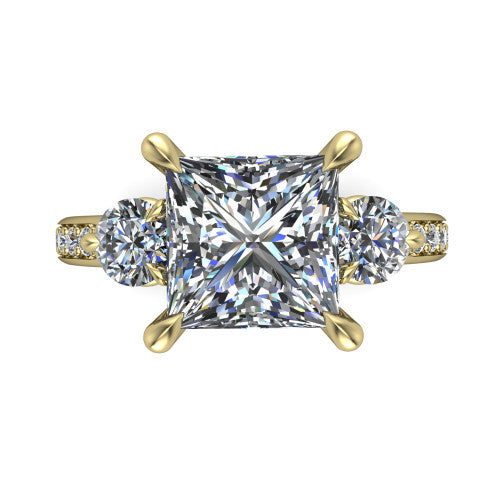Blake princess three stone engagement ring in 18K Yellow Gold, top-down view showing the center diamond flanked by two round side stones in a classic three stone setting