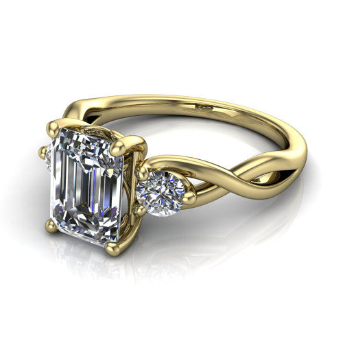 Alina emerald three stone engagement ring in 14K Yellow Gold, three-quarter perspective showing the emerald center between two round side stones above a twisted vine band