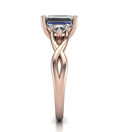 Alina emerald three stone engagement ring in 18K Rose Gold, side profile showing the twisted infinity vine band sweeping to the emerald center