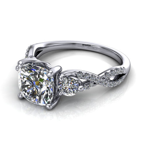 Ryleigh cushion three stone engagement ring in Platinum, three-quarter perspective showing the cushion center between two round side stones above a twisted pav&eacute; band