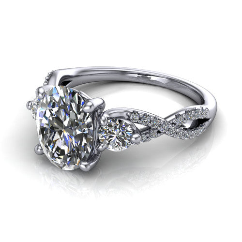 Ryleigh oval three stone engagement ring in 18K White Gold, three-quarter perspective showing the oval center between two round side stones above a twisted pav&eacute; band
