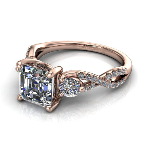 Ryleigh square emerald three stone engagement ring in 14K Rose Gold, three-quarter perspective showing the square emerald center between two round side stones above a twisted pav&eacute; band