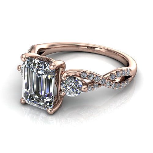 Ryleigh emerald three stone engagement ring in 14K Rose Gold, three-quarter perspective showing the emerald center between two round side stones above a twisted pav&eacute; band
