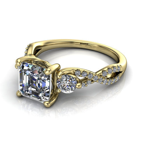 Ryleigh square emerald three stone engagement ring in 18K Yellow Gold, three-quarter perspective showing the square emerald center between two round side stones above a twisted pav&eacute; band
