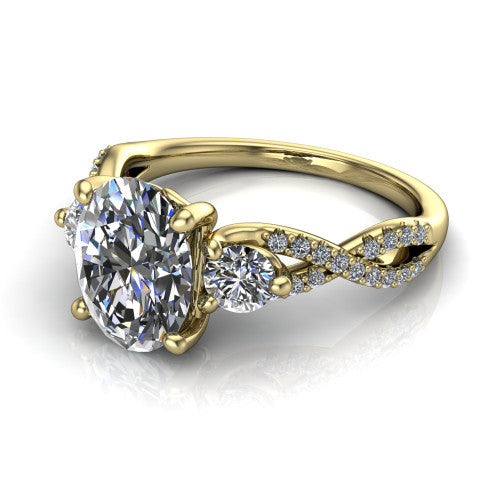 Ryleigh oval three stone engagement ring in 18K Yellow Gold, three-quarter perspective showing the oval center between two round side stones above a twisted pav&eacute; band