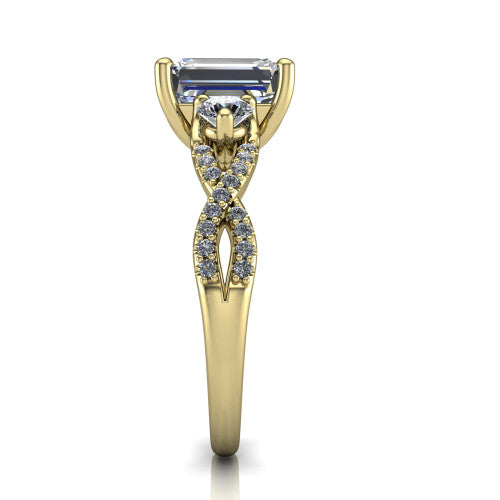 Ryleigh emerald three stone engagement ring in 18K Yellow Gold, side profile showing the twisted pav&eacute; infinity band sweeping to the emerald center