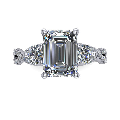 Ryleigh emerald three stone engagement ring in 18K White Gold, top-down view showing the emerald center flanked by two round accent diamonds and the pav&eacute; twist