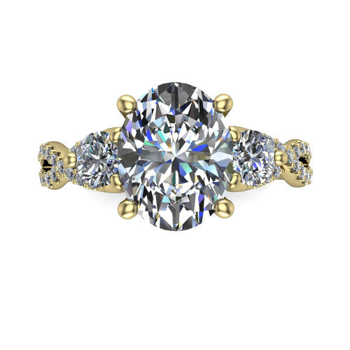 Ryleigh oval three stone engagement ring in 18K Yellow Gold, top-down view showing the oval center flanked by two round accent diamonds and the pav&eacute; twist
