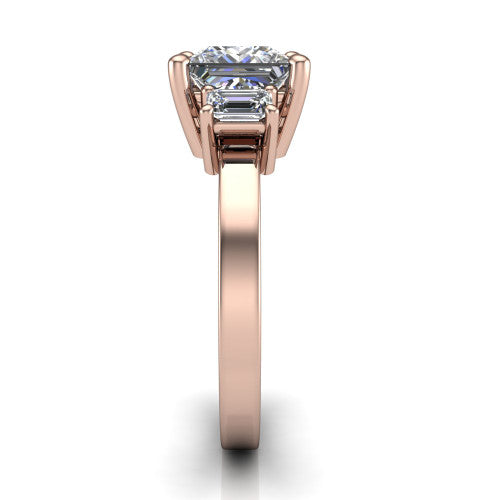 Madelyn princess three stone engagement ring in 18K Rose Gold with emerald-cut side stones, side profile showing the plain band and step-cut side stones