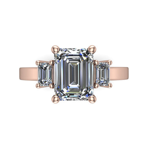 Madelyn emerald three stone engagement ring in 18K Rose Gold with emerald-cut side stones, top-down view of the center and emerald-cut side stones