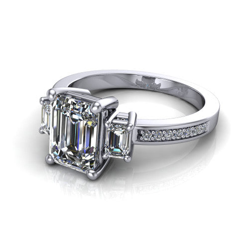 Freya emerald three stone engagement ring in 14K White Gold, three-quarter perspective showing the emerald center between two emerald cut side stones above a pav&eacute; band