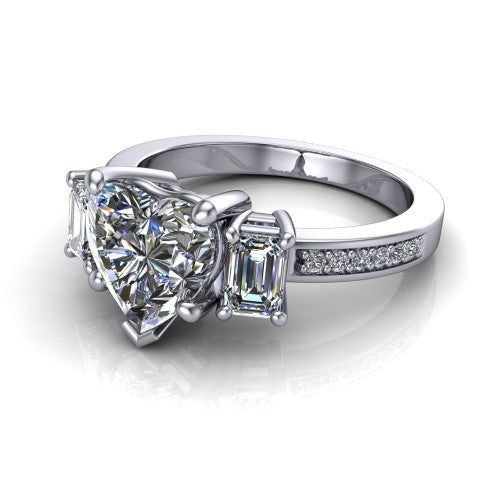 Freya heart three stone engagement ring in Platinum, three-quarter perspective showing the heart center between two emerald cut side stones above a pav&eacute; band