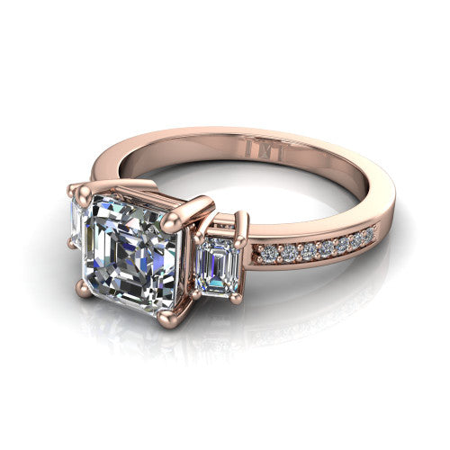 Freya square emerald three stone engagement ring in 14K Rose Gold, three-quarter perspective showing the square emerald center between two emerald cut side stones above a pav&eacute; band