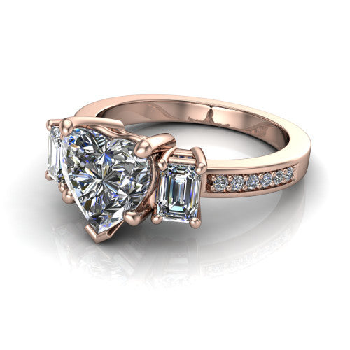 Freya heart three stone engagement ring in 18K Rose Gold, three-quarter perspective showing the heart center between two emerald cut side stones above a pav&eacute; band