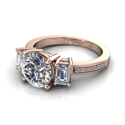 Freya round three stone engagement ring in 18K Rose Gold, three-quarter perspective showing the round center between two emerald cut side stones above a pav&eacute; band