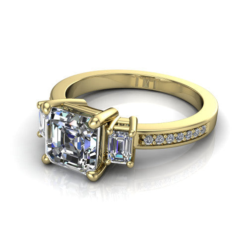 Freya square emerald three stone engagement ring in 14K Yellow Gold, three-quarter perspective showing the square emerald center between two emerald cut side stones above a pav&eacute; band