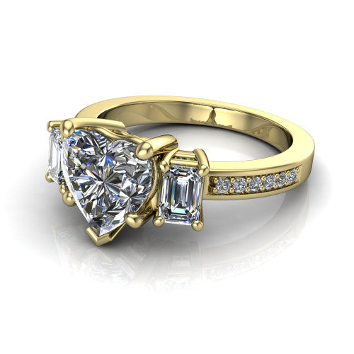 Freya heart three stone engagement ring in 14K Yellow Gold, three-quarter perspective showing the heart center between two emerald cut side stones above a pav&eacute; band