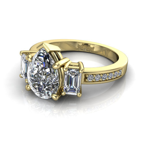 Freya pear three stone engagement ring in 18K Yellow Gold, three-quarter perspective showing the pear center between two emerald cut side stones above a pav&eacute; band