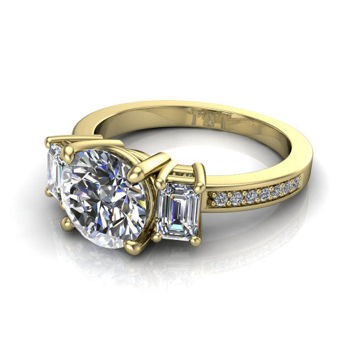 Freya round three stone engagement ring in 14K Yellow Gold, three-quarter perspective showing the round center between two emerald cut side stones above a pav&eacute; band