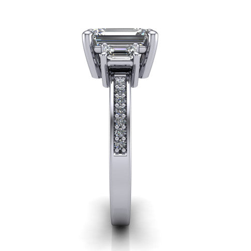 Freya emerald three stone engagement ring in Platinum, side profile showing the pav&eacute; milgrain band and the three-stone setting in profile