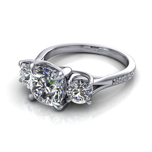 Ruth cushion three stone engagement ring in Platinum, three-quarter perspective showing the cushion center between two round side stones above a pav&eacute; band