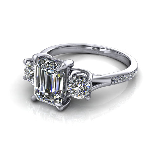 Ruth emerald three stone engagement ring in 18K White Gold, three-quarter perspective showing the emerald center between two round side stones above a pav&eacute; band
