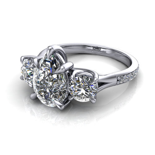 Ruth pear three stone engagement ring in Platinum, three-quarter perspective showing the pear center between two round side stones above a pav&eacute; band