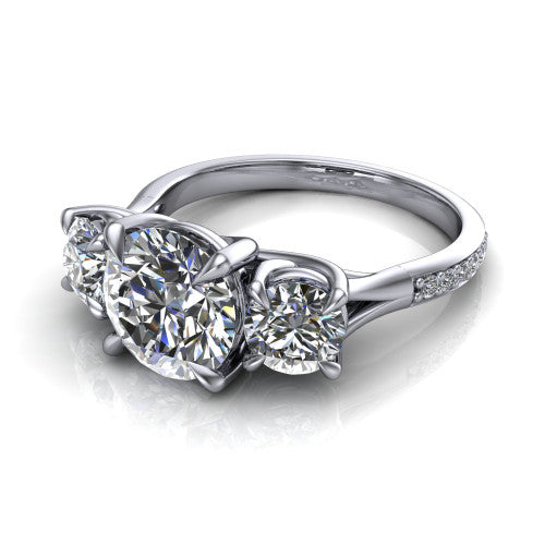 Ruth round three stone engagement ring in Platinum, three-quarter perspective showing the round center between two round side stones above a pav&eacute; band