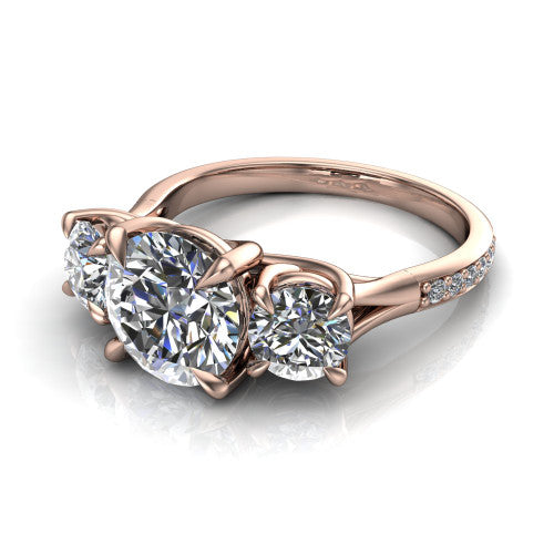 Ruth round three stone engagement ring in 14K Rose Gold, three-quarter perspective showing the round center between two round side stones above a pav&eacute; band