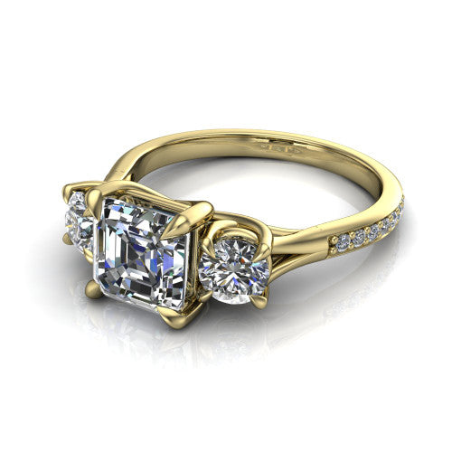 Ruth square emerald three stone engagement ring in 14K Yellow Gold, three-quarter perspective showing the square emerald center between two round side stones above a pav&eacute; band