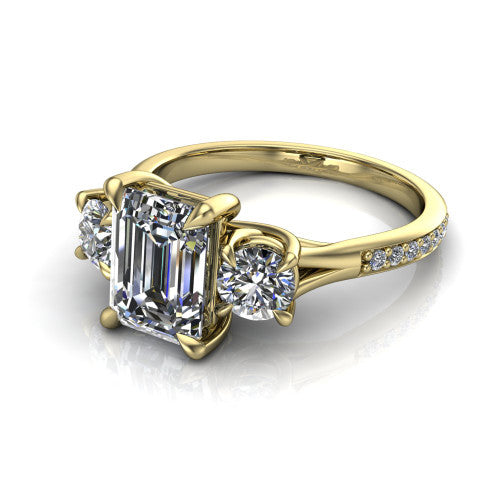 Ruth emerald three stone engagement ring in 14K Yellow Gold, three-quarter perspective showing the emerald center between two round side stones above a pav&eacute; band