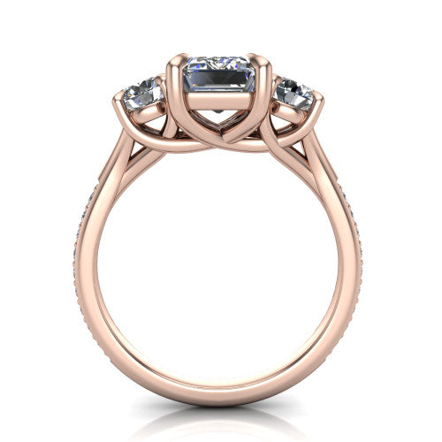 Ruth emerald three stone engagement ring in 14K Rose Gold, through-finger front profile showing the three-stone head and scrolled gallery above the pav&eacute; band