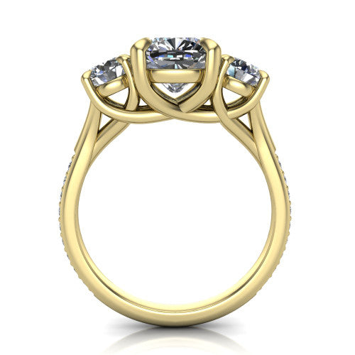 Ruth cushion three stone engagement ring in 14K Yellow Gold, through-finger front profile showing the three-stone head and scrolled gallery above the pav&eacute; band