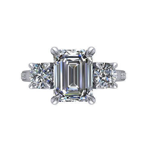 Ruth emerald three stone engagement ring in Platinum, top-down view showing the emerald center flanked by two round accent diamonds