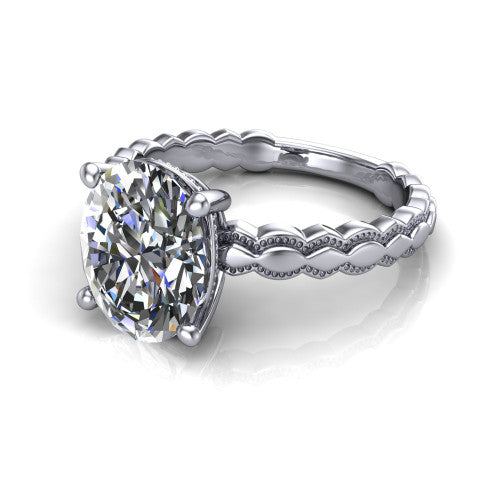 Flora oval solitaire engagement ring in 14K White Gold, three-quarter perspective showing the oval center on claw prongs above a scalloped beaded milgrain band