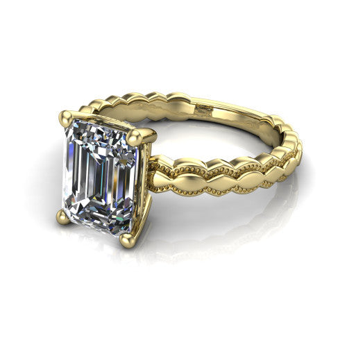 Flora emerald solitaire engagement ring in 14K Yellow Gold, three-quarter perspective showing the emerald center on claw prongs above a scalloped beaded milgrain band