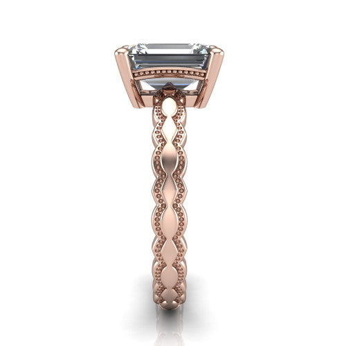 Flora emerald solitaire engagement ring in 14K Rose Gold, side profile showing the scalloped milgrain band and the open basket beneath the emerald center