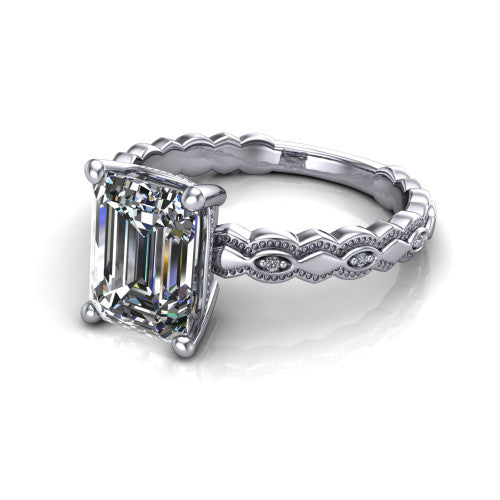 Ivy emerald solitaire engagement ring in Platinum, three-quarter perspective showing the solitaire center diamond above a vintage marquise-and-dot milgrain band