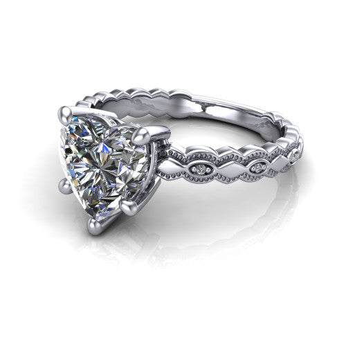 Ivy heart solitaire engagement ring in Platinum, three-quarter perspective showing the solitaire center diamond above a vintage marquise-and-dot milgrain band