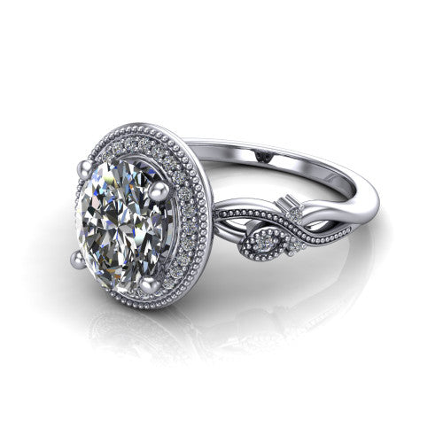 Eliana oval halo engagement ring in 18K White Gold, three-quarter perspective showing the milgrain-edged halo center above vintage filigree scroll shoulders