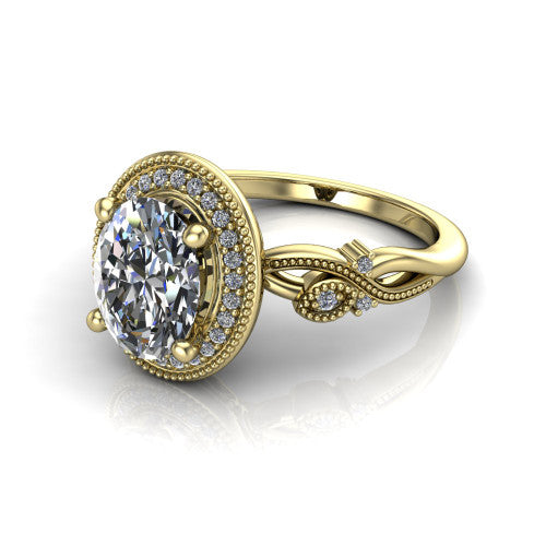 Eliana oval halo engagement ring in 14K Yellow Gold, three-quarter perspective showing the milgrain-edged halo center above vintage filigree scroll shoulders