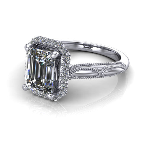 Caroline emerald vintage halo engagement ring in Platinum, three-quarter perspective showing the emerald center in a squared pav&eacute; milgrain halo above an openwork split shank