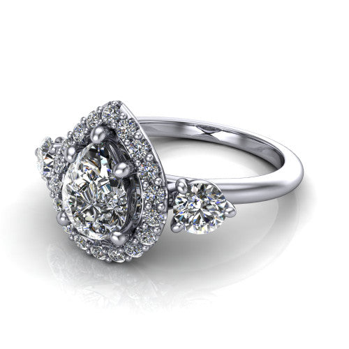 Carol pear three stone halo engagement ring in 18K White Gold, three-quarter perspective showing the pear center in a squared pav&eacute; halo flanked by two round side stones above a plain band