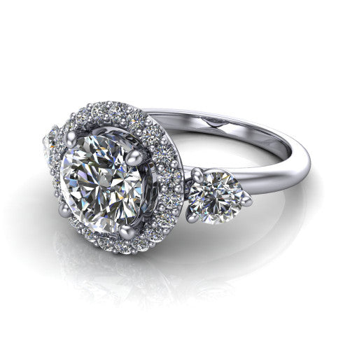 Carol round three stone halo engagement ring in 14K White Gold, three-quarter perspective showing the round center in a squared pav&eacute; halo flanked by two round side stones above a plain band